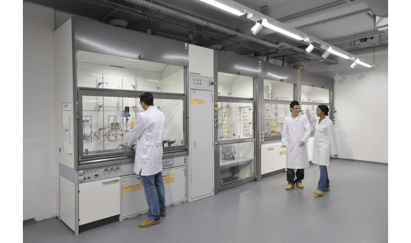 shows how people in laboratory working surrounded by fume hood